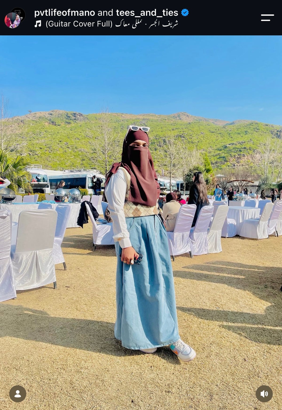 Customer in a cream top with a blue tiered maxi skirt at an outdoor event