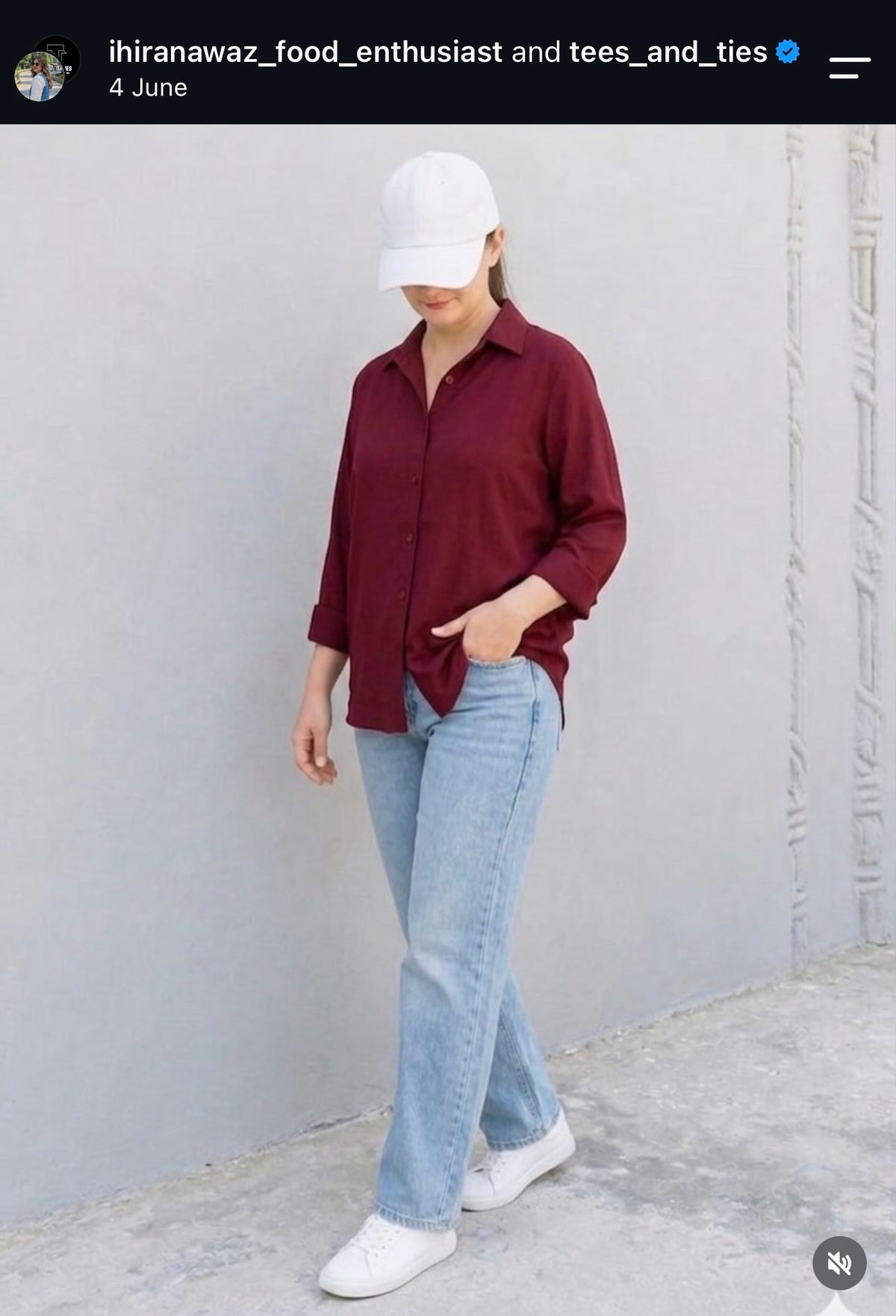 Customer in a maroon button down shirt with light blue jeans and white sneakers