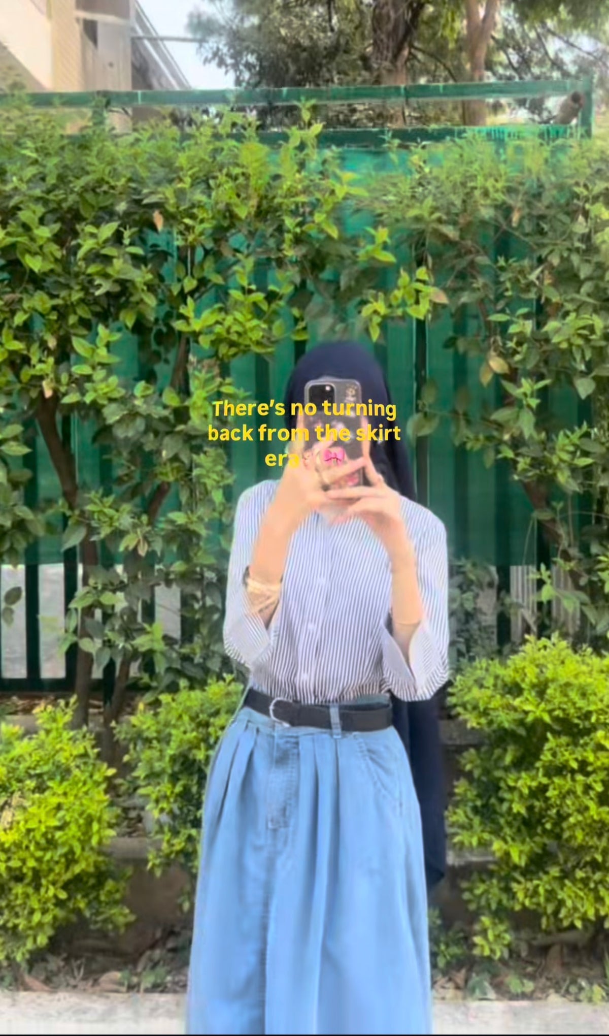 Customer in a blue striped shirt with a belted blue skirt