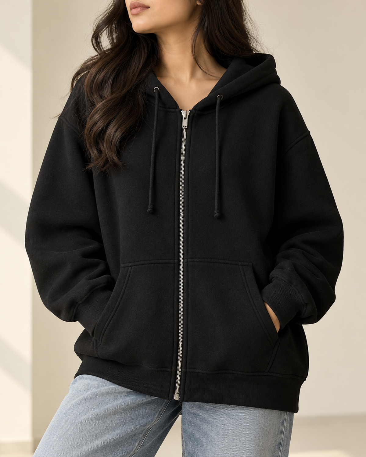 Black oversized zip-up hoodie with a drawstring hood, by TeesnTies, view 1 of 4