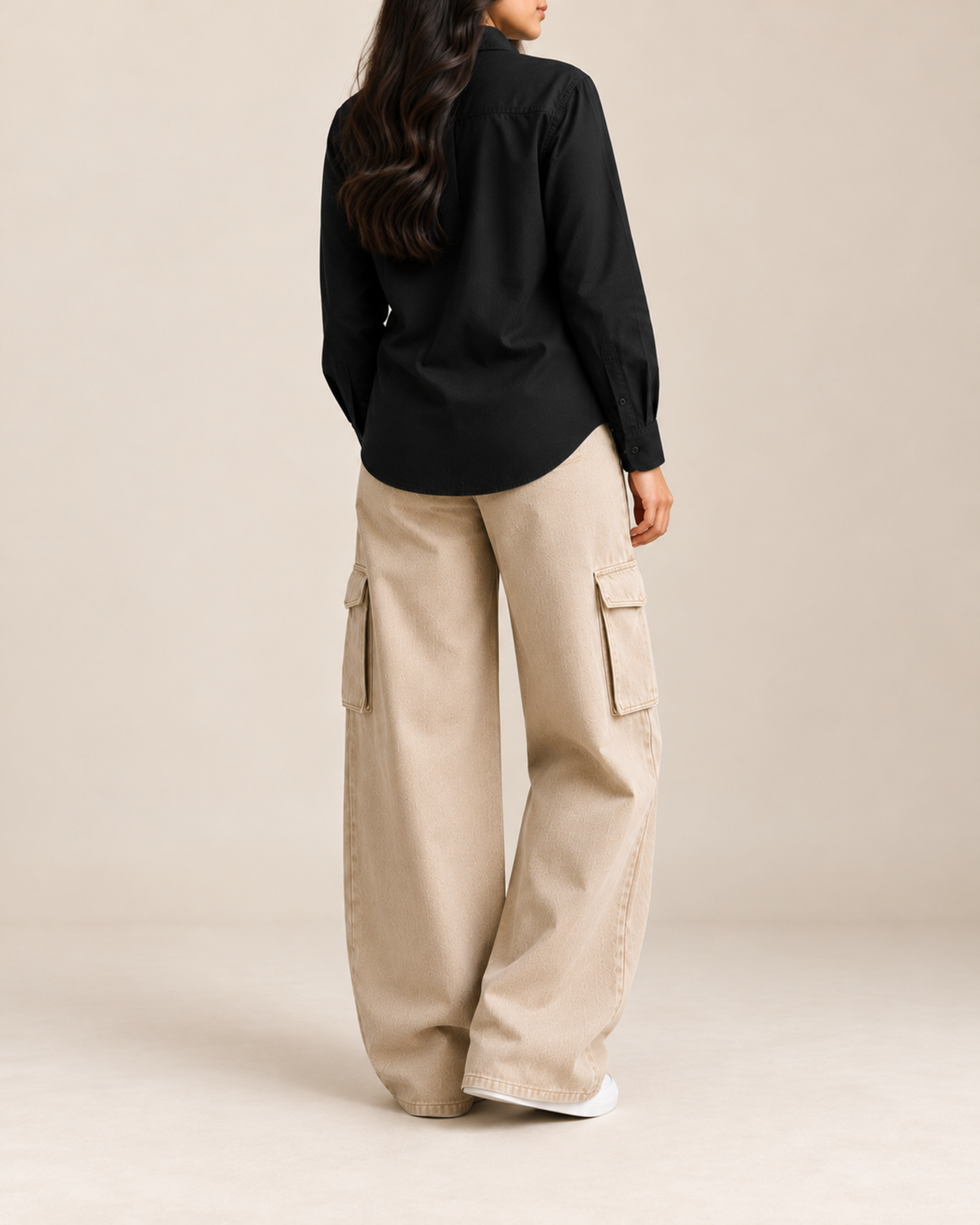 Back view of black button-down shirt with beige cargo jeans