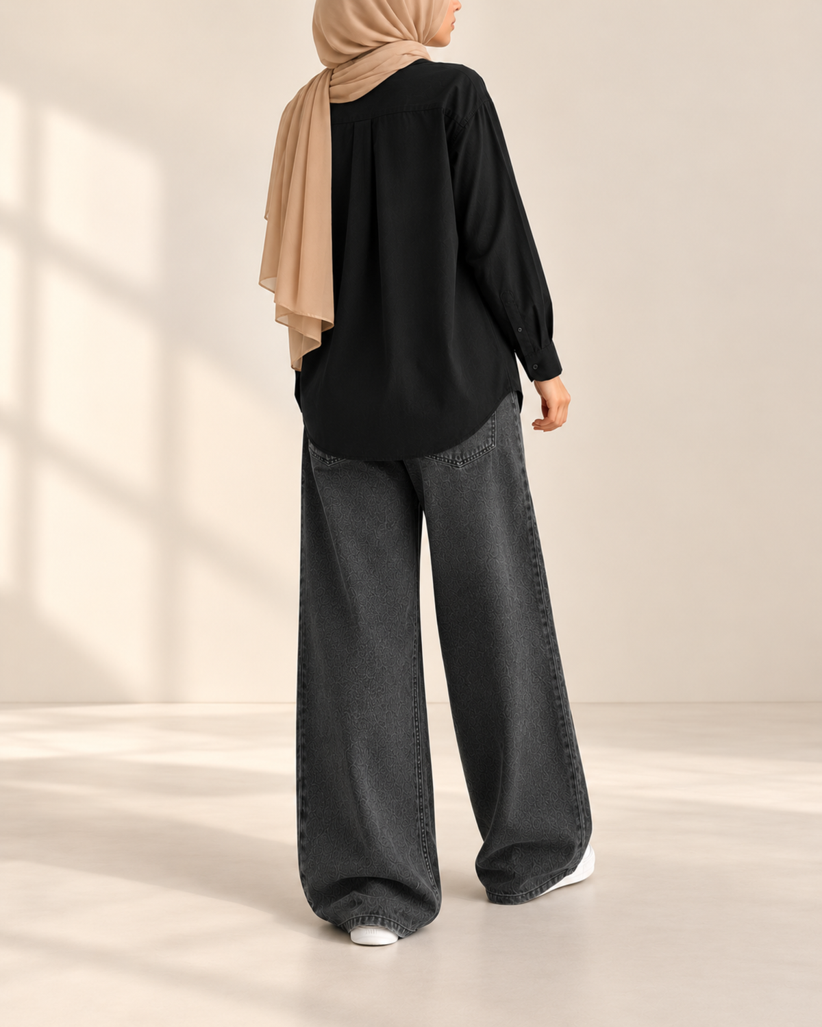 Back view of black button-down shirt with charcoal wide-leg jeans