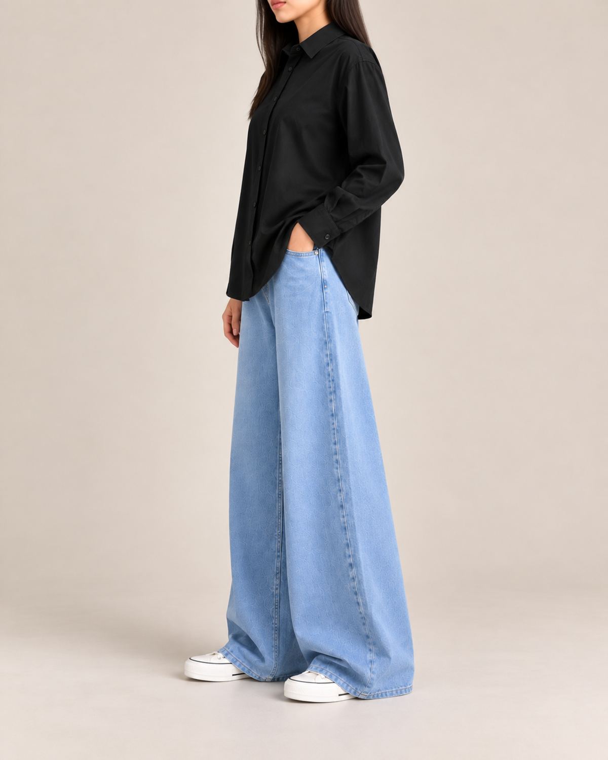 Black button-down shirt and sky blue wide-leg jeans, side view