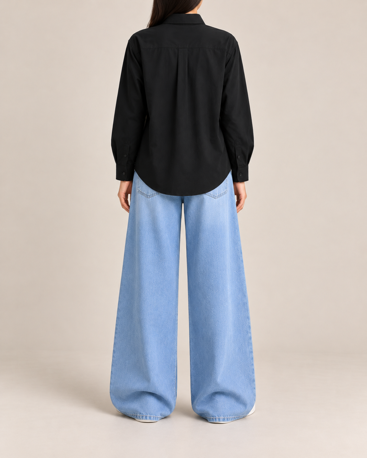 Back view of black button-down shirt with sky blue wide-leg jeans