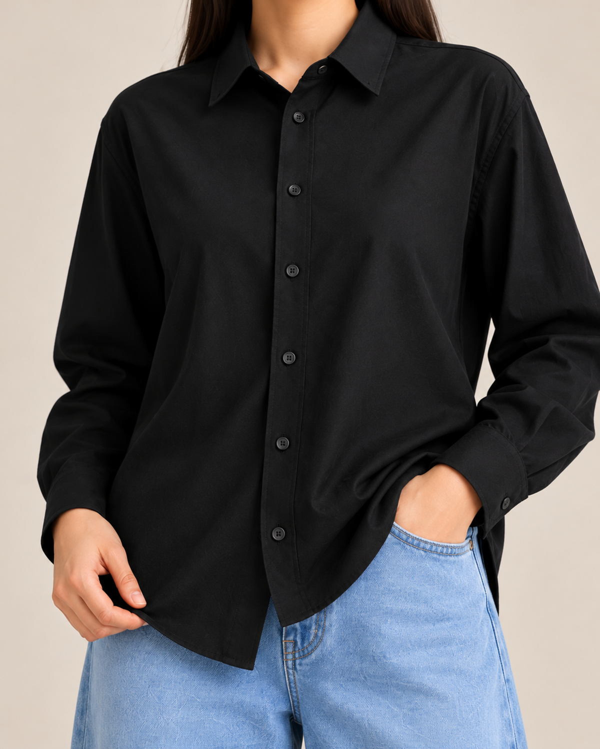 Close-up of black button-down shirt with sky blue denim jeans