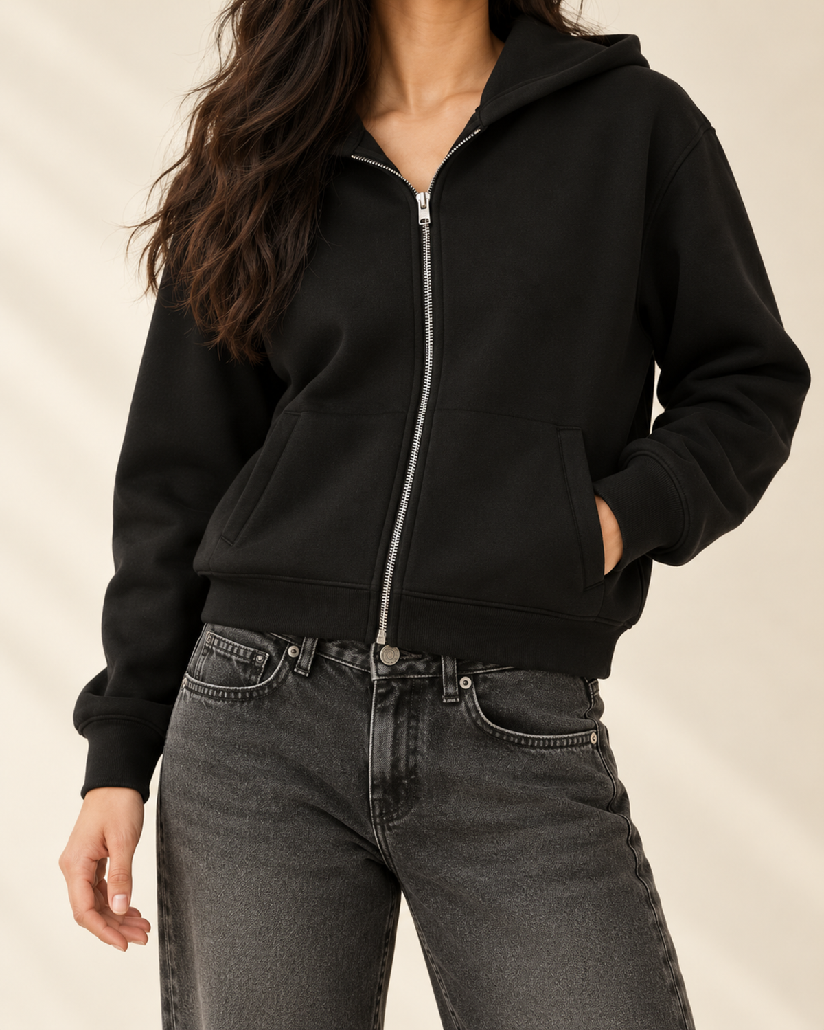 Close-up of black zip-up hoodie zip and charcoal denim