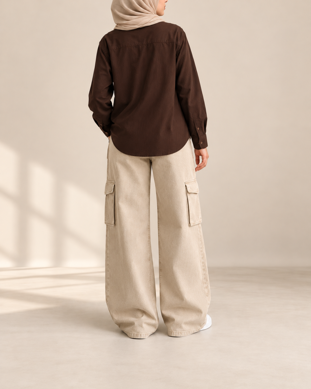 Back view of brown button-down shirt with beige cargo jeans