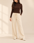 Brown ribbed high-neck top with beige wide-leg flapper trousers, front view