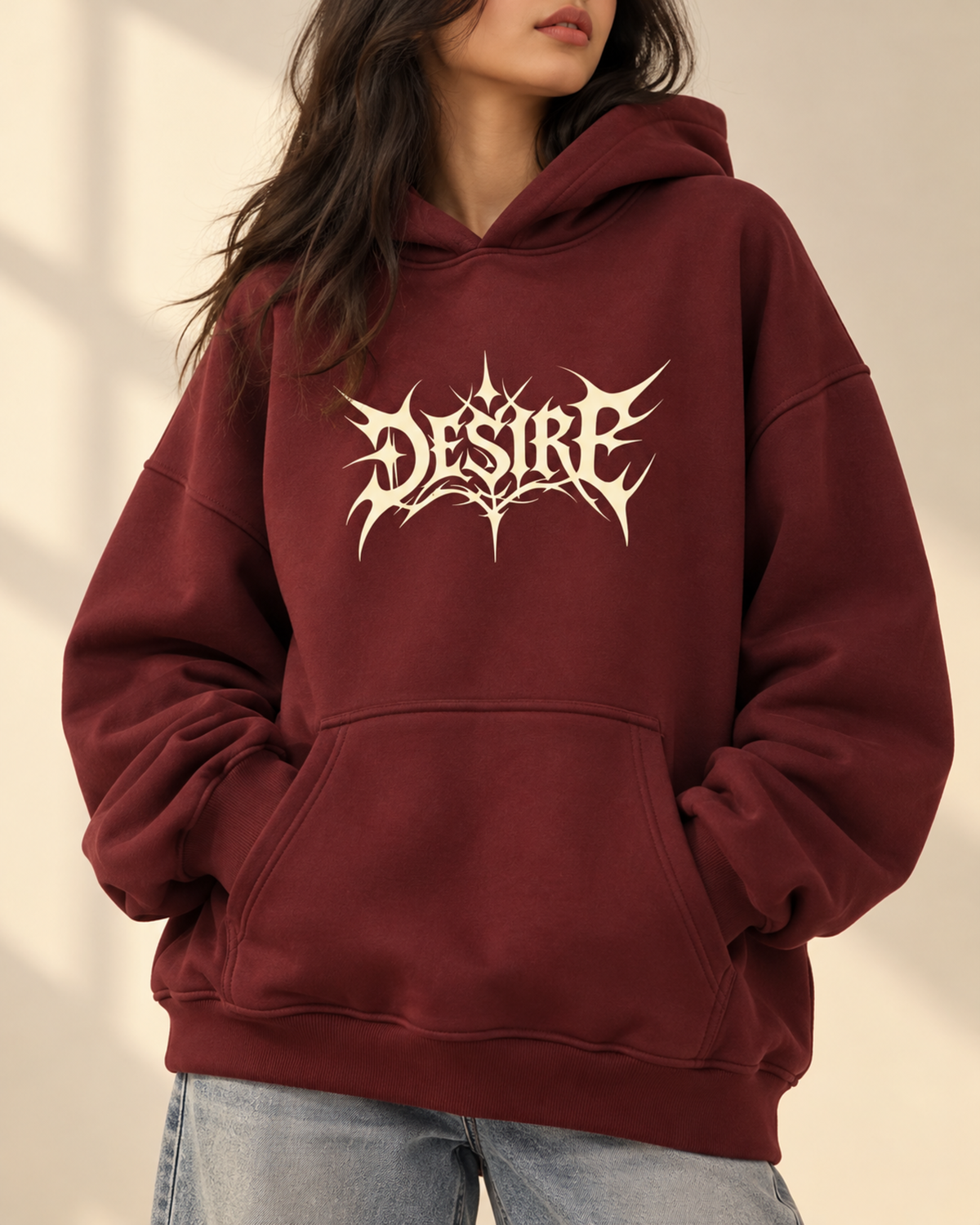 Maroon hoodie with cream Desire chest print, front view