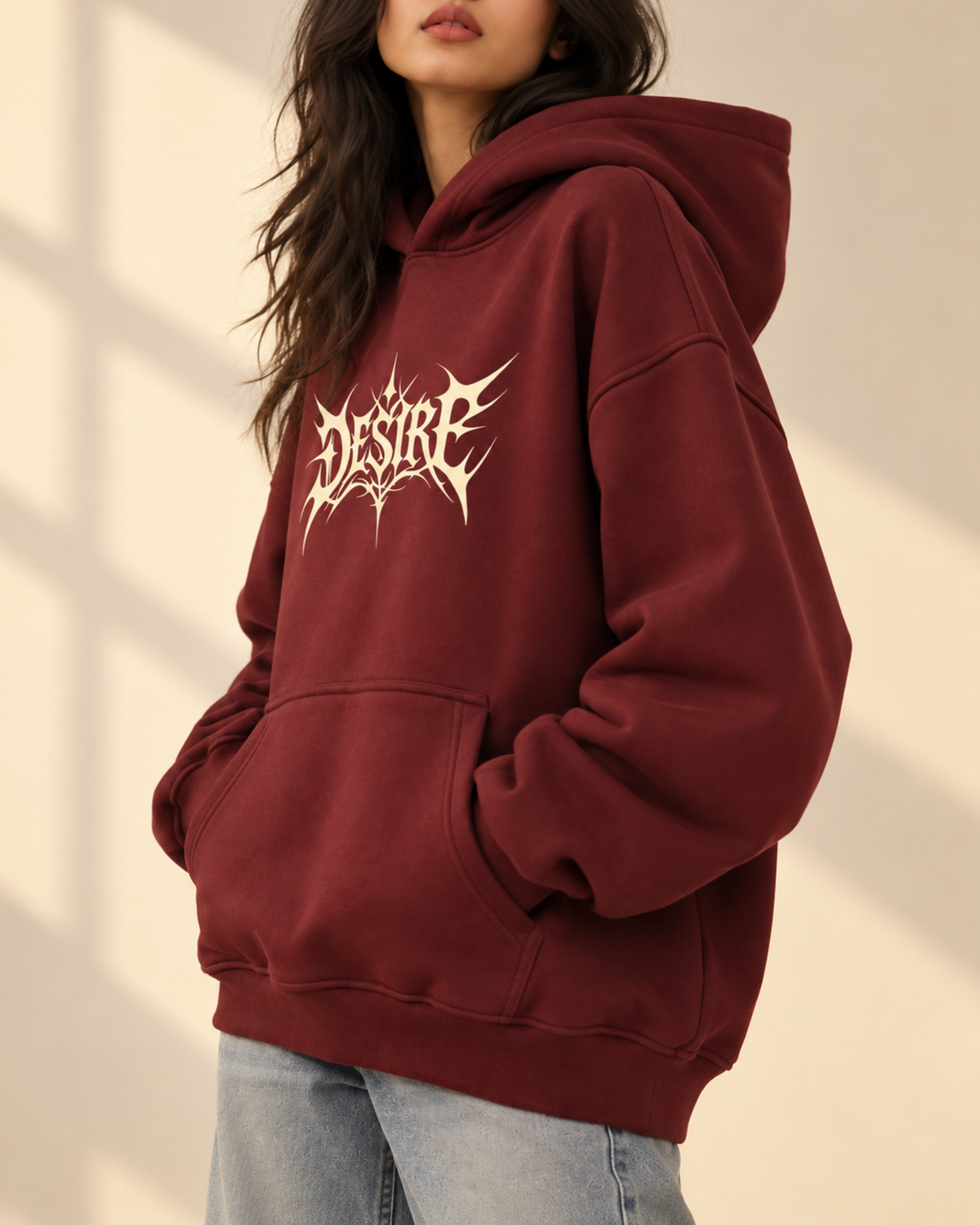 Maroon hoodie with cream Desire chest print, side view