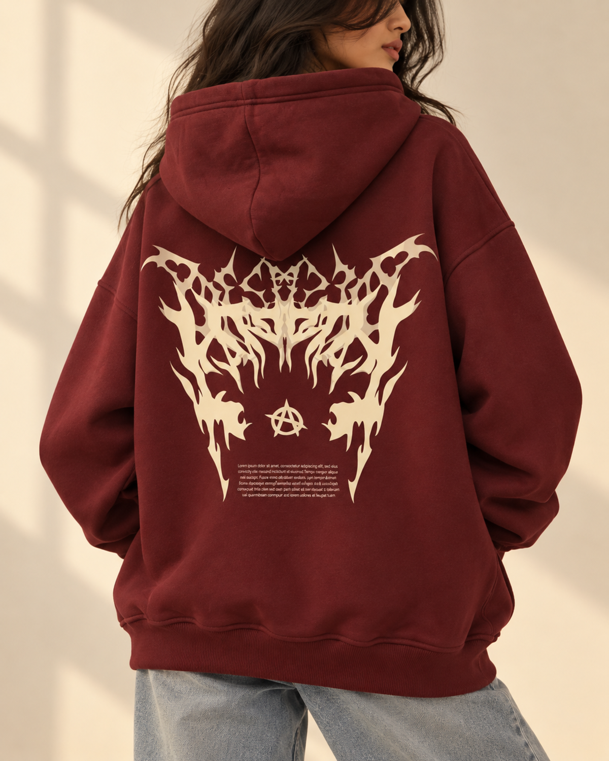 Back view of maroon hoodie with large cream gothic print