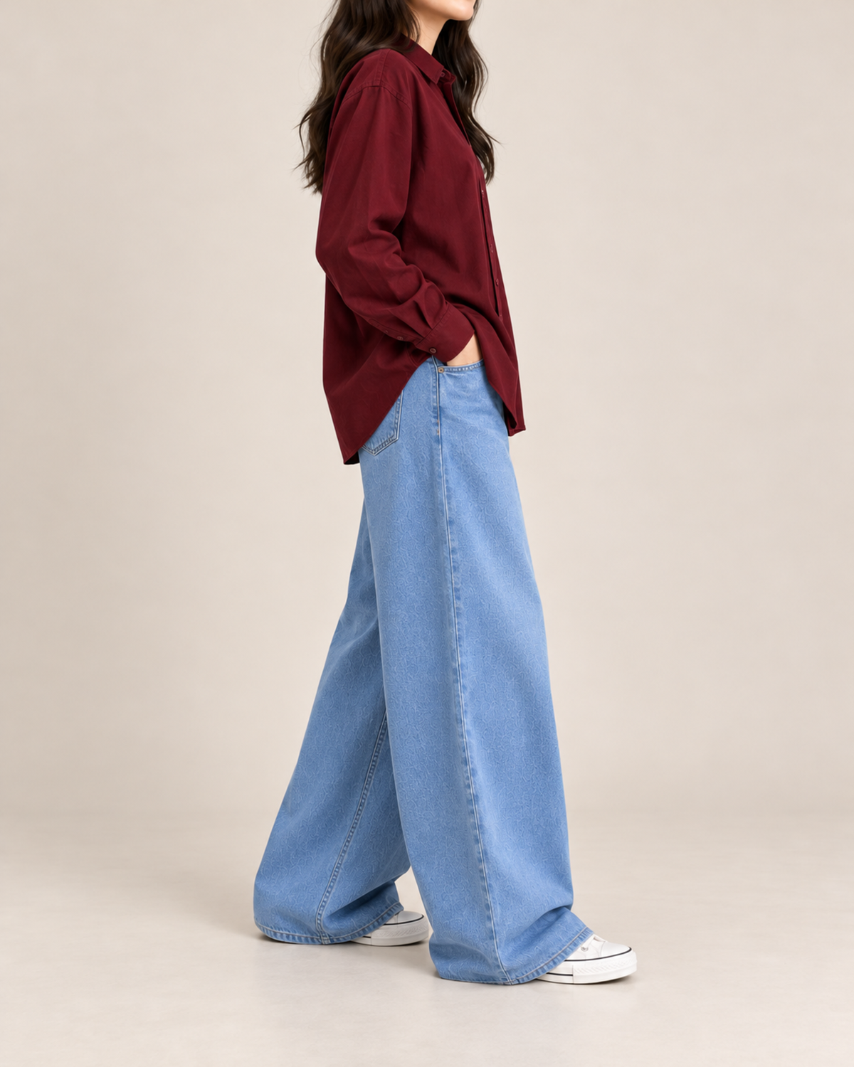Maroon button-down shirt and sky blue wide-leg jeans, side view