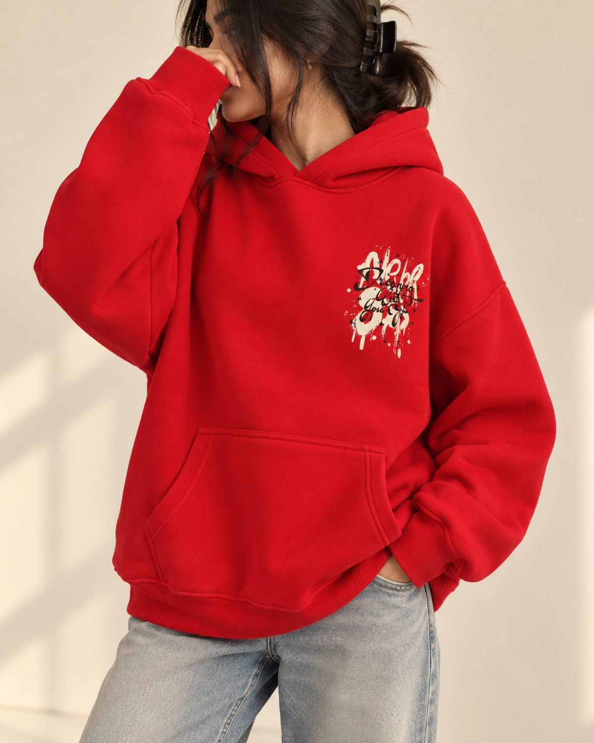 Red hoodie with graffiti-style chest print, front view