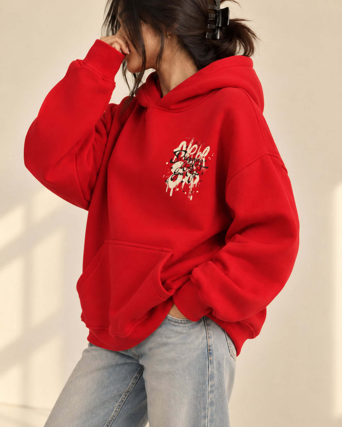Red hoodie with graffiti-style chest print, side view
