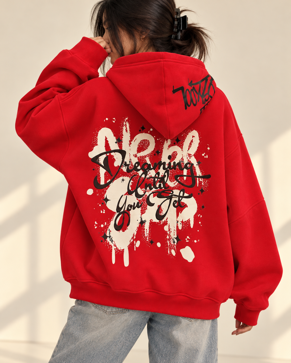 Back view of red hoodie with large graffiti-style print