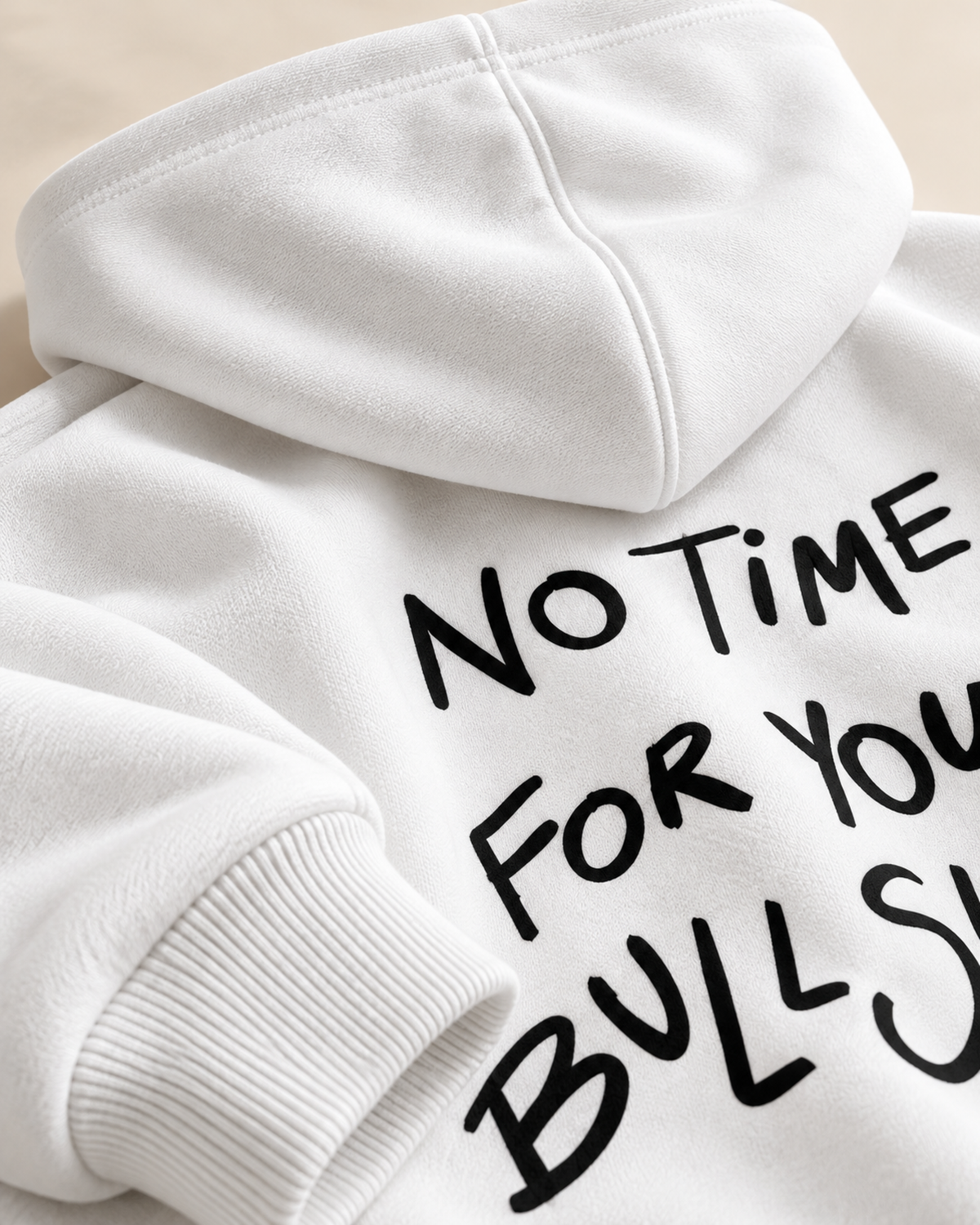 Close-up of black handwritten slogan print on white hoodie