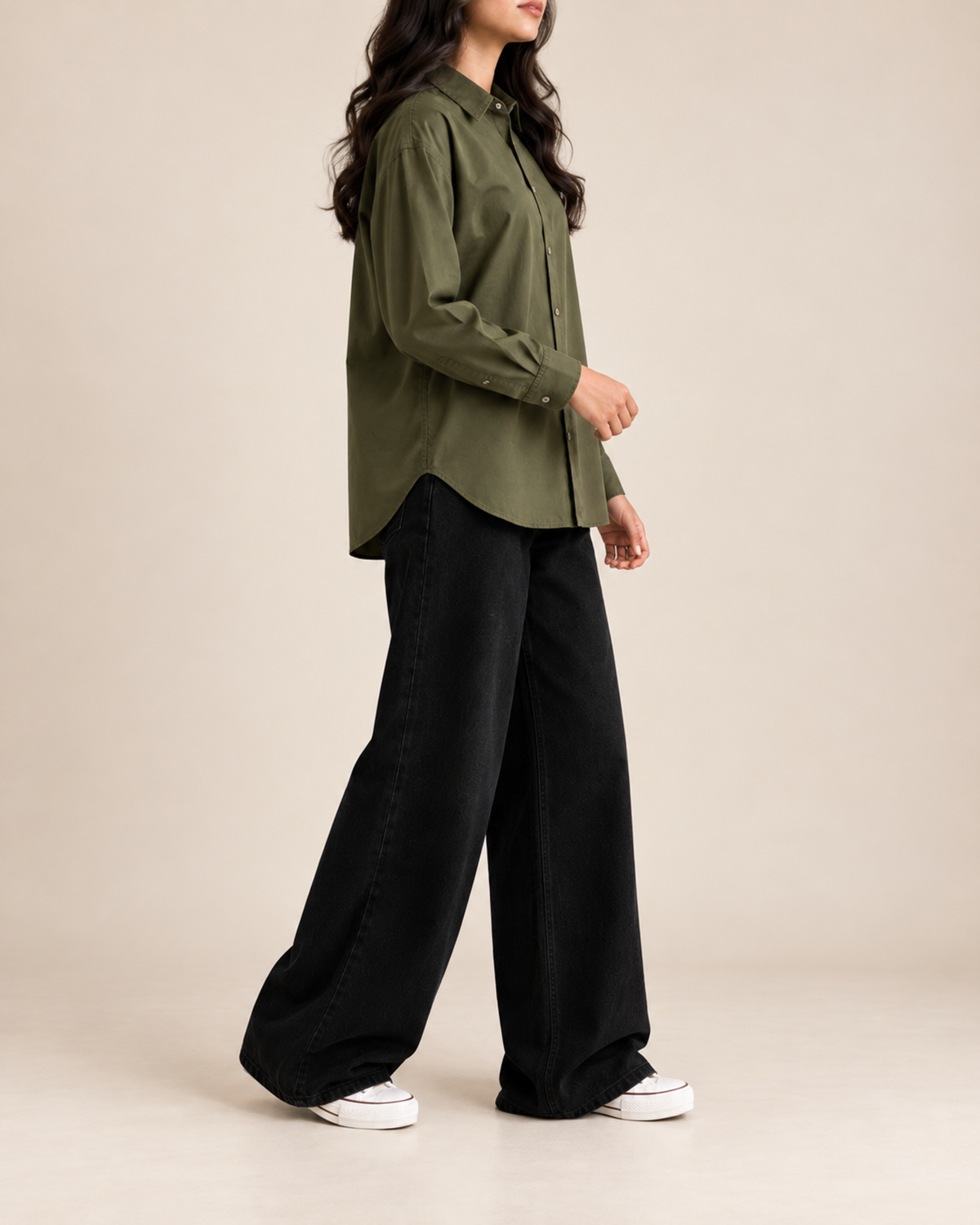 Olive button-down shirt and black wide-leg jeans, side view