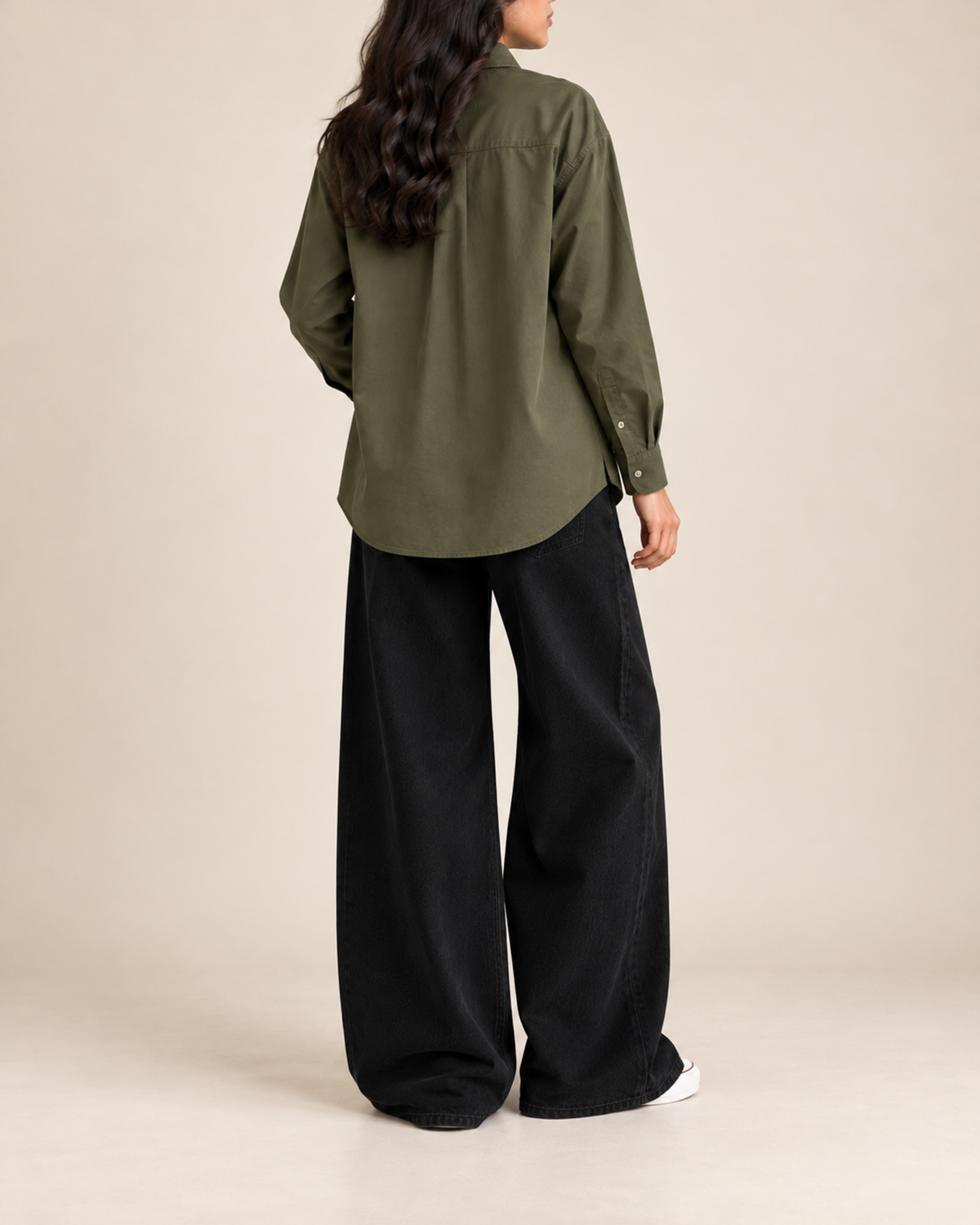 Back view of olive button-down shirt with black wide-leg jeans
