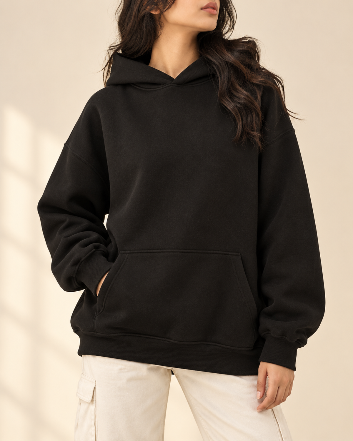 Black oversized hoodie with white cargo trousers, front view