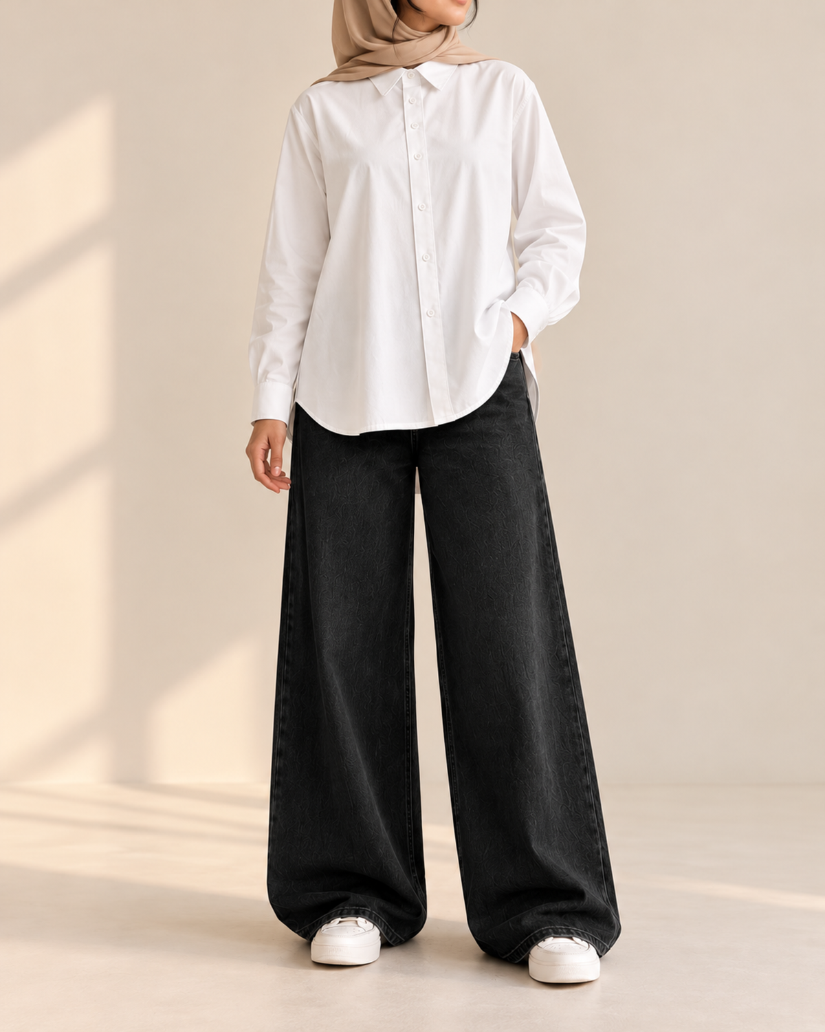 Oversized white button-down shirt with black wide-leg jeans, front view